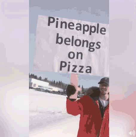 Protester with "Pineapple belongs on Pizza" sign.